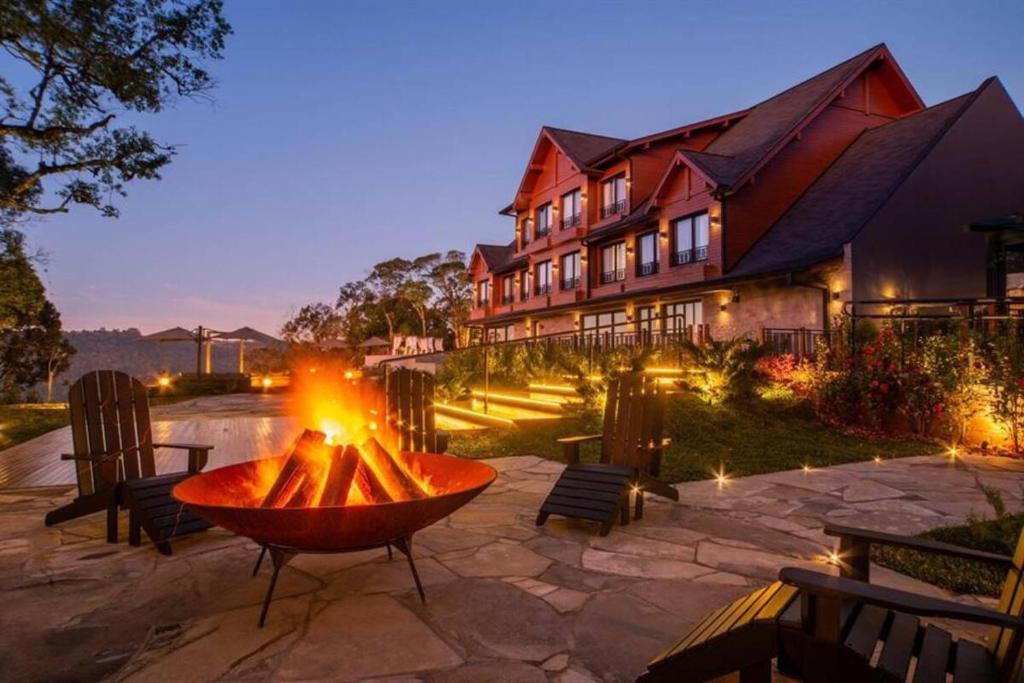 a fire pit in a patio in front of a building at Chateau Laghetto Collection in Gramado