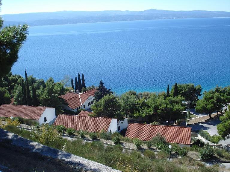 a group of houses and trees and the water at APARTMENTS ON THE BEACH IN BAY MALA LUKA in Omiš