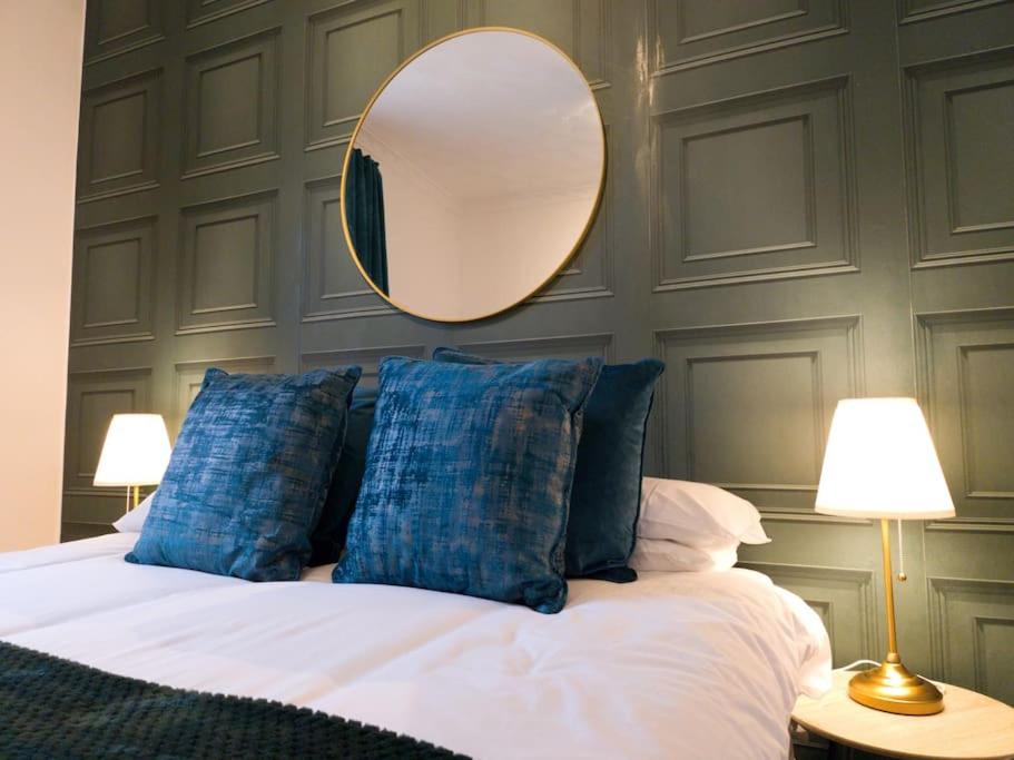 a bedroom with a bed with a mirror on the wall at Double King Bed Central Apartment by Property Promise in Cardiff