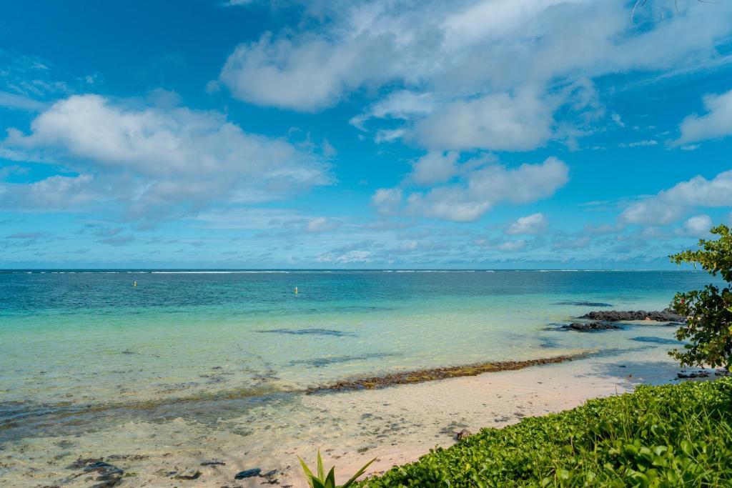 a view of the ocean from the shore of a beach at Stunning Belle Mare Beachfront luxury Apartment in Belle Mare