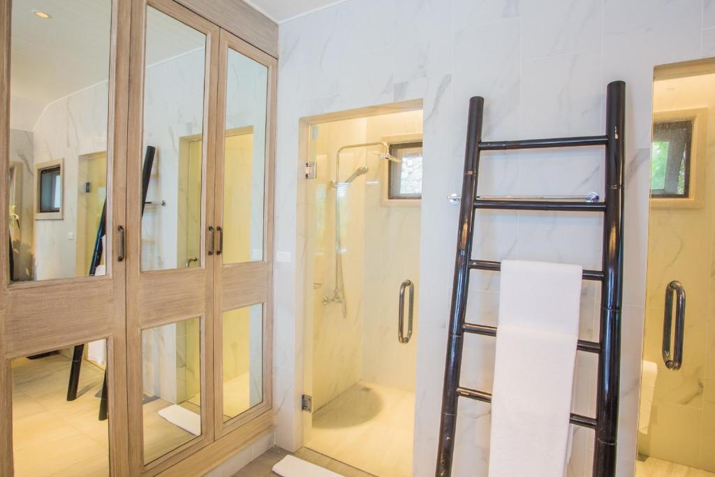 a bathroom with a ladder next to a glass door at Lang- Villa Amara，Kamala beach luxury villa in Surin Beach
