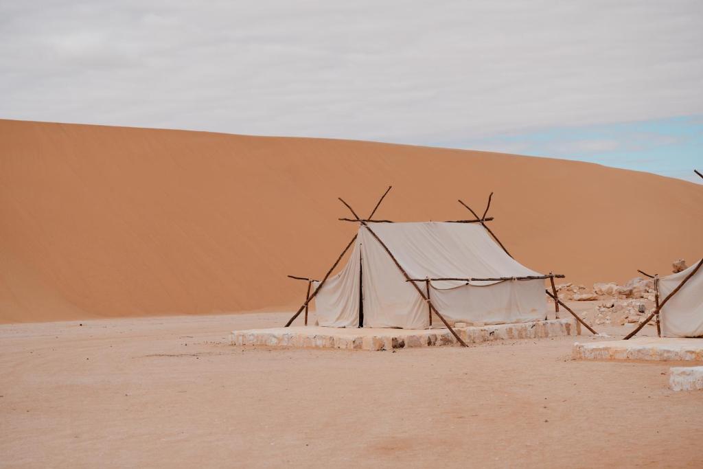 a tent in the middle of a desert at Tzila Camp in Fayoum Center