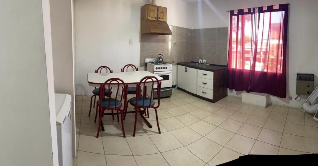 uma cozinha com uma mesa e cadeiras em Deptos San Luis em San Rafael