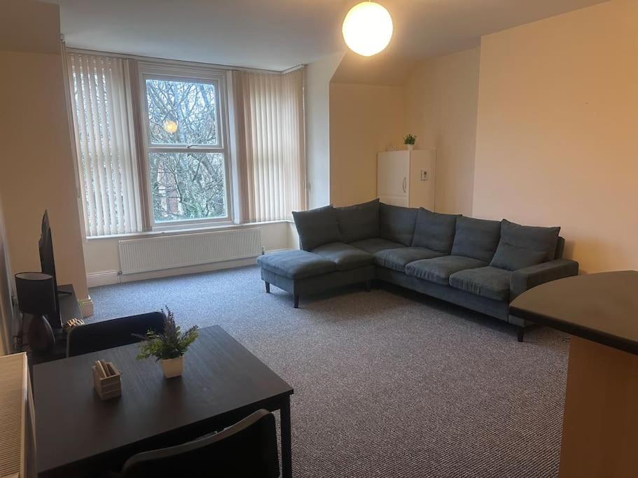 a living room with a couch and a table at City centre apartment in Sunderland