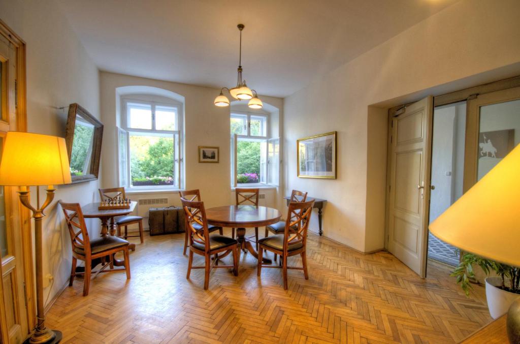 a dining room with a table and chairs and windows at Wenceslas Square Hotel - Czech Leading Hotels in Prague