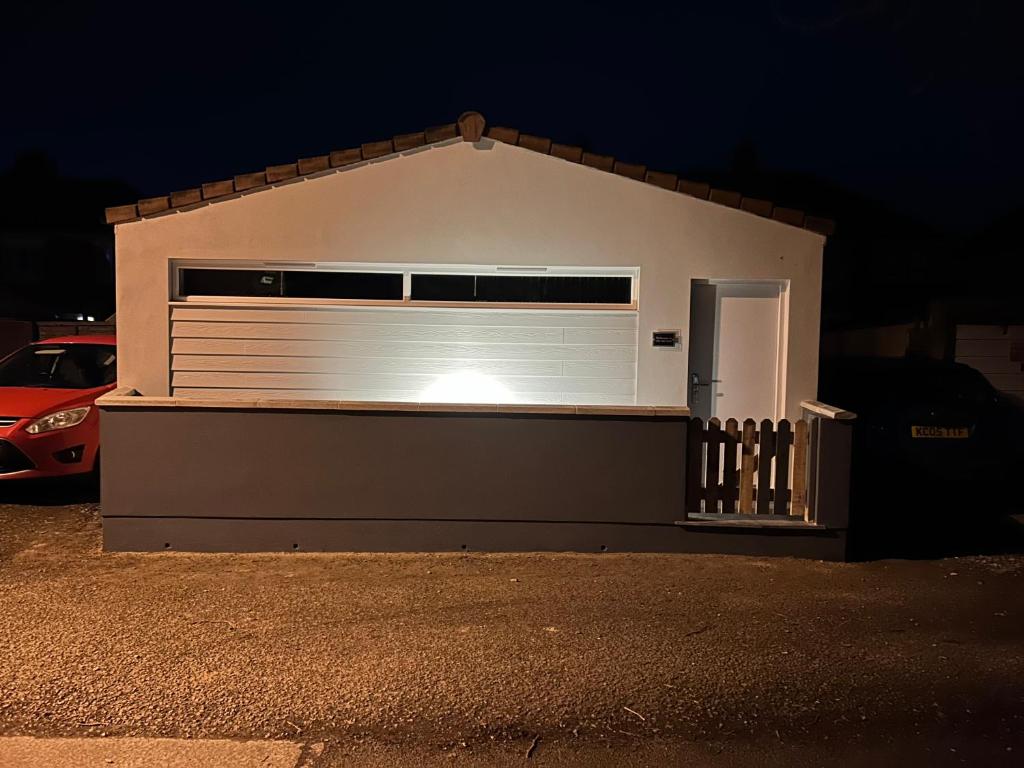 a garage with a large white garage door at night at THE ARCHERS in Glastonbury