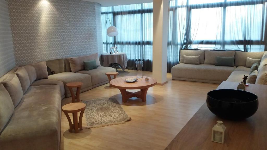 a living room with a couch and a table at Bright 2 Bedroom House with Great Front View, Casablanca in Casablanca