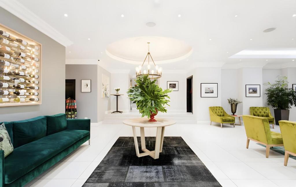 a living room with a green couch and a table at Tranquil Haven in Cape Town