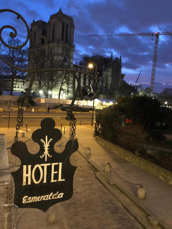 a sign for a hotel in front of a building at Hotel Esmeralda in Paris