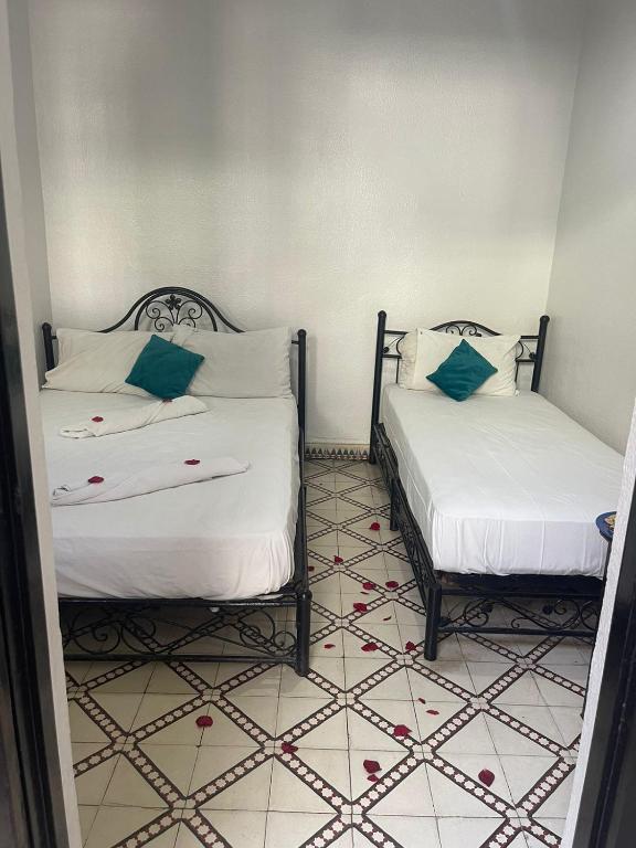 Postel nebo postele na pokoji v ubytování HOTEL EL AMAL