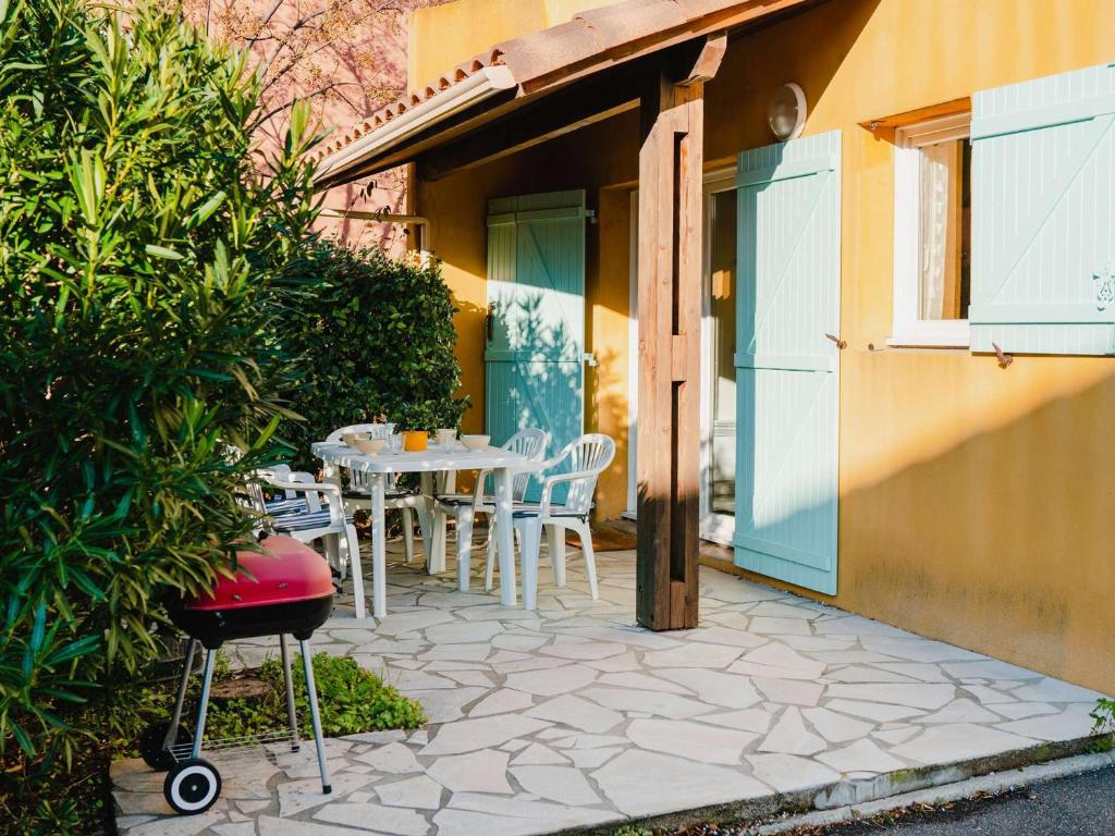 une terrasse avec une table et des chaises dans une maison dans l'établissement Pavillon 4 pièces avec garage, terrasse, et tout confort à Narbonne-Plage, 5 couchages - FR-1-409-115, à Narbonne-Plage
