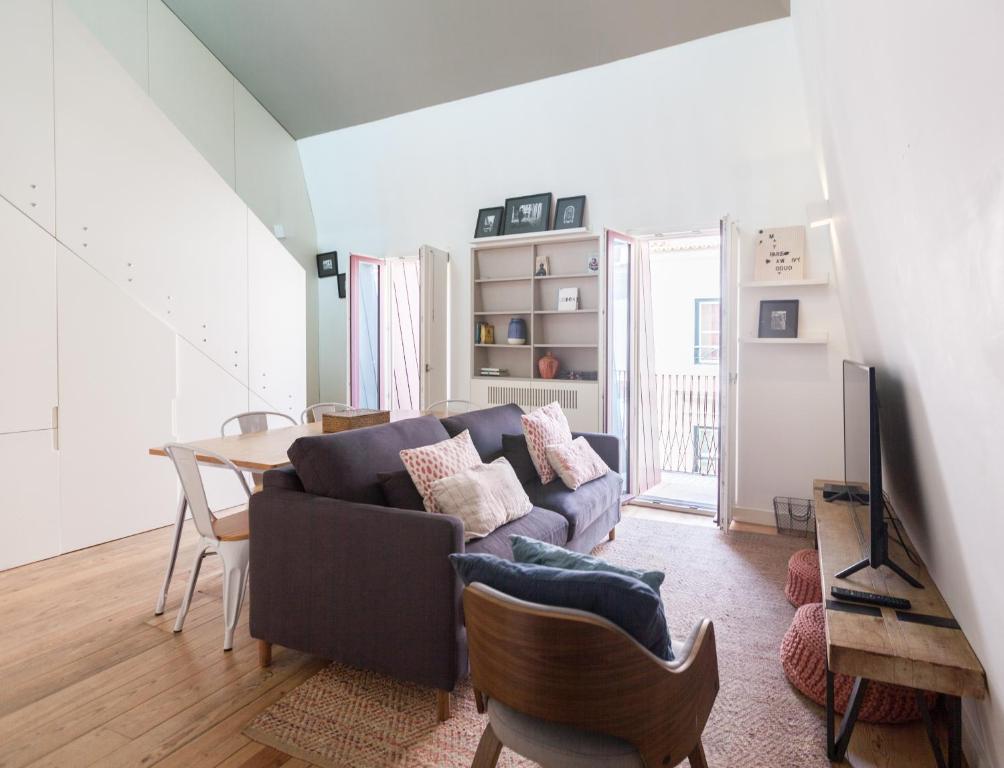 a living room with a couch and a table at FLH Bairro Alto Design Flat in Lisbon