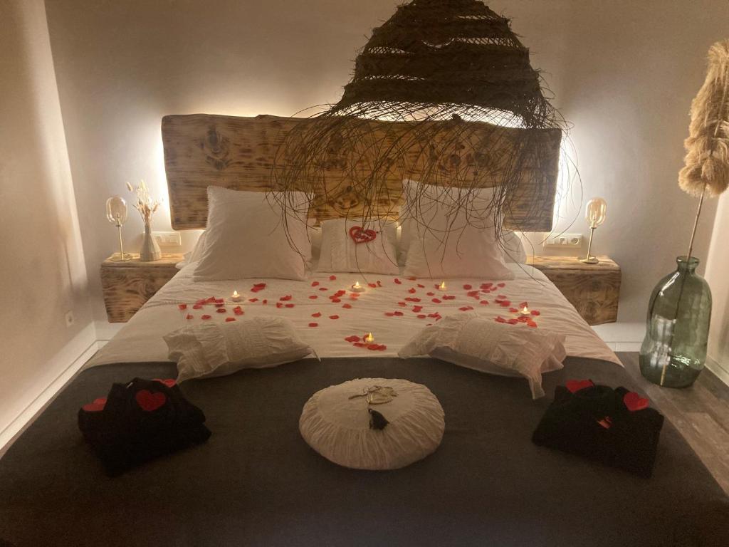 a bedroom with a large bed with candles on it at Au coeur du 11 in Beyne-Heusay