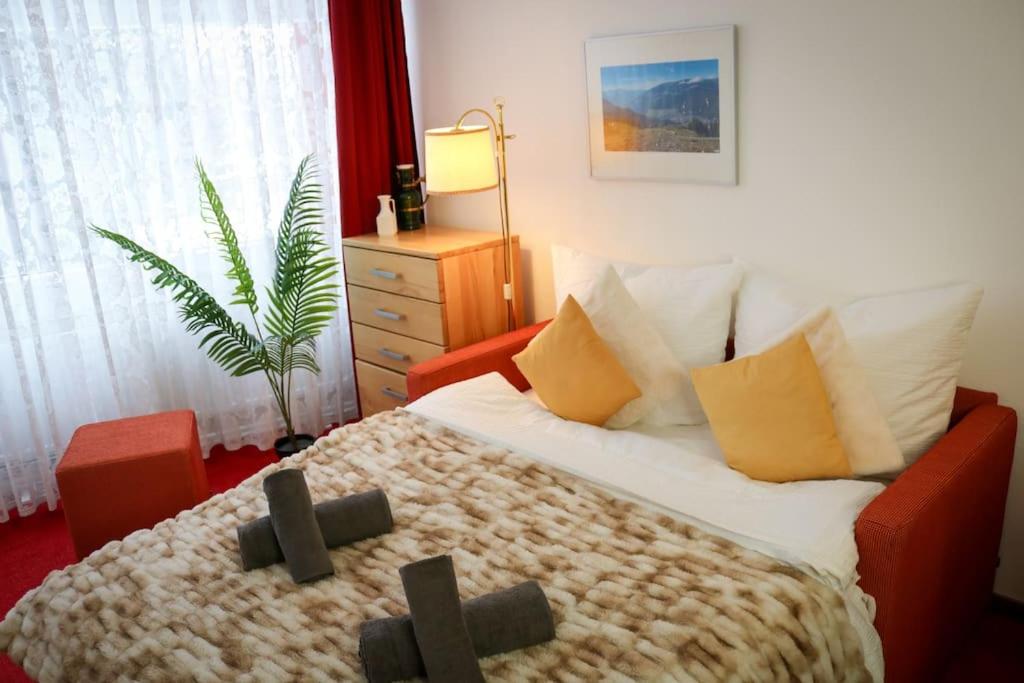 a bedroom with a bed with a cross on it at Schluchseezauber 1123 - Alm Chic mit Pool & Sauna in Schluchsee