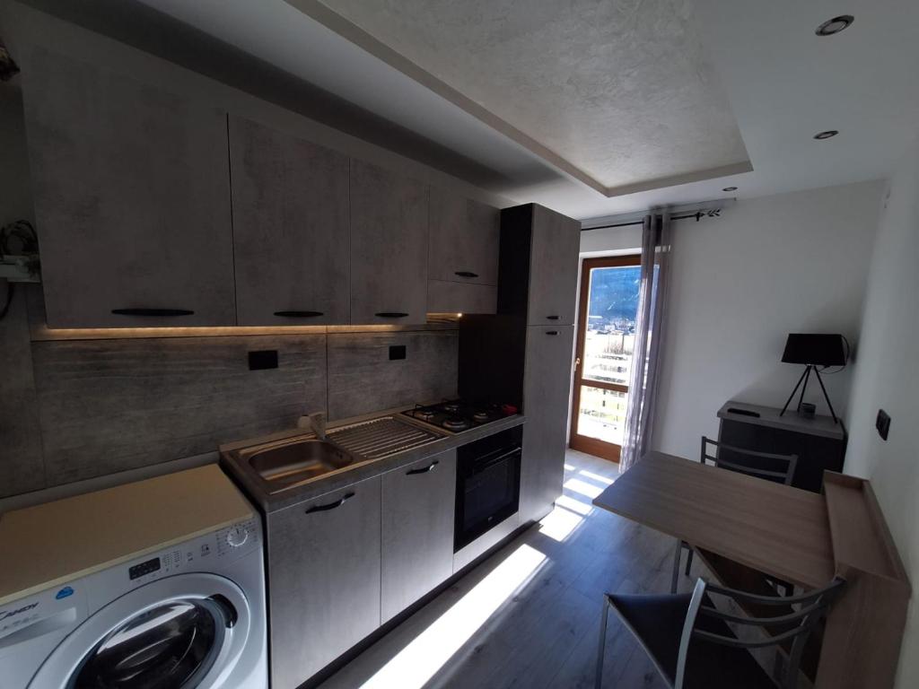 a kitchen with a washing machine and a sink at Centro Mezzano Romantica, affitto camere in Mezzano