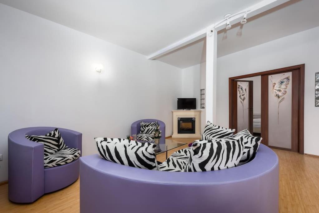 a living room with two couches with zebra at Central Apartament Predeal Nr 6 in Predeal