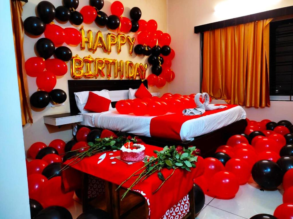 a room with two beds with red and black balloons at Goroomgo Blue Bell Bhubaneswar in Bhubaneshwar