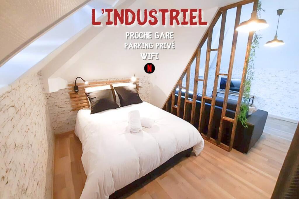 a bedroom with a white bed in a room at L’Industriel in Sens