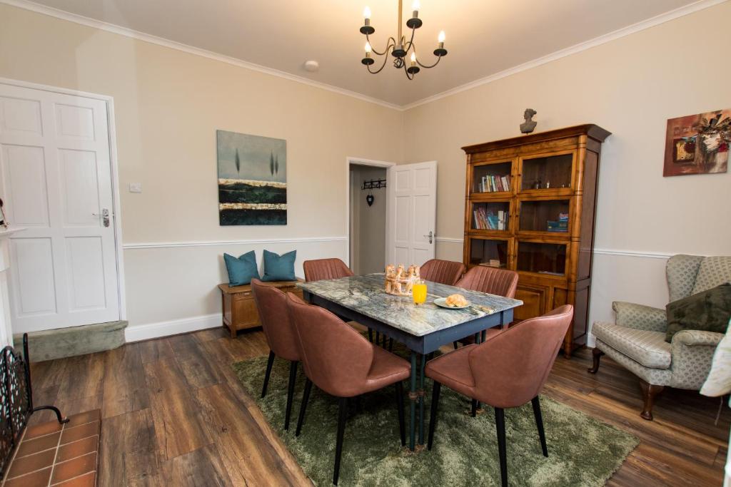 a dining room with a table and chairs at Peak Period Property in Chesterfield