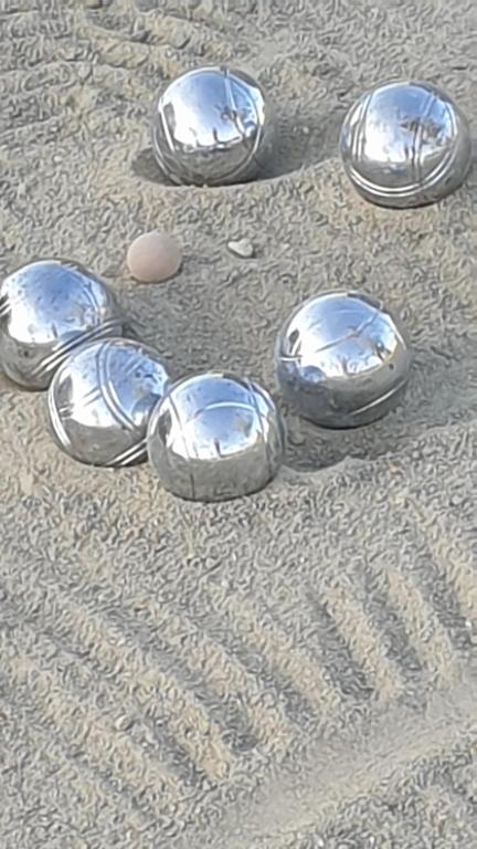 a group of silver dishes sitting on the ground at Gîte d&#39;Anne et Ulysse in Sept-Frères