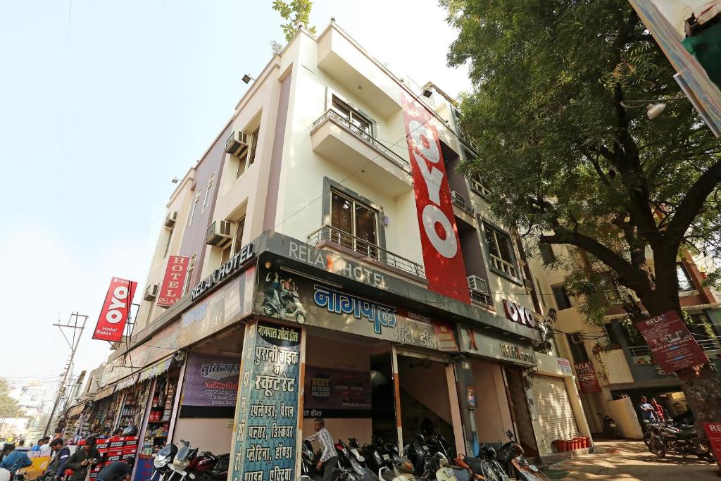 a building with motorcycles parked in front of it at Hotel Relax in Gwalior