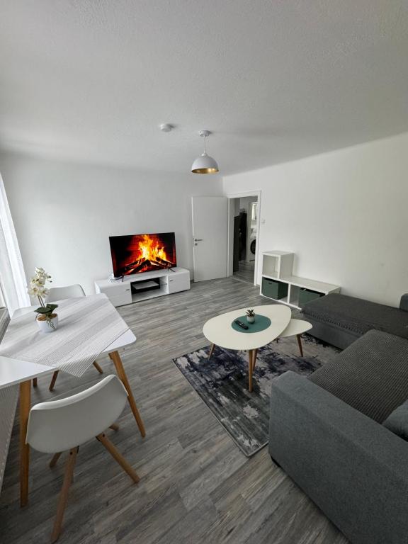 a living room with a couch and a fireplace at Apartment Vlora 2-Naturblick in Villach