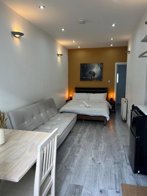 a living room with a bed and a couch at Studio in Camden, King's Cross in London