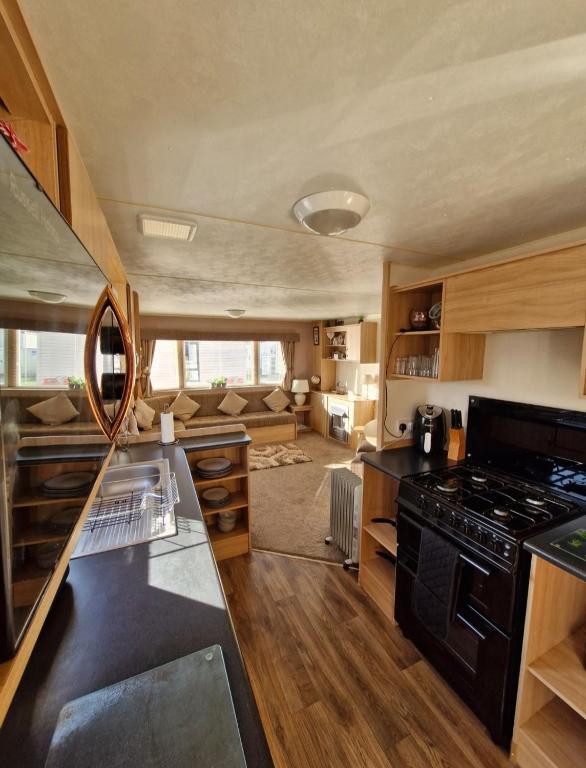 a kitchen with a stove and a counter top at 35 Irby way in Skegness