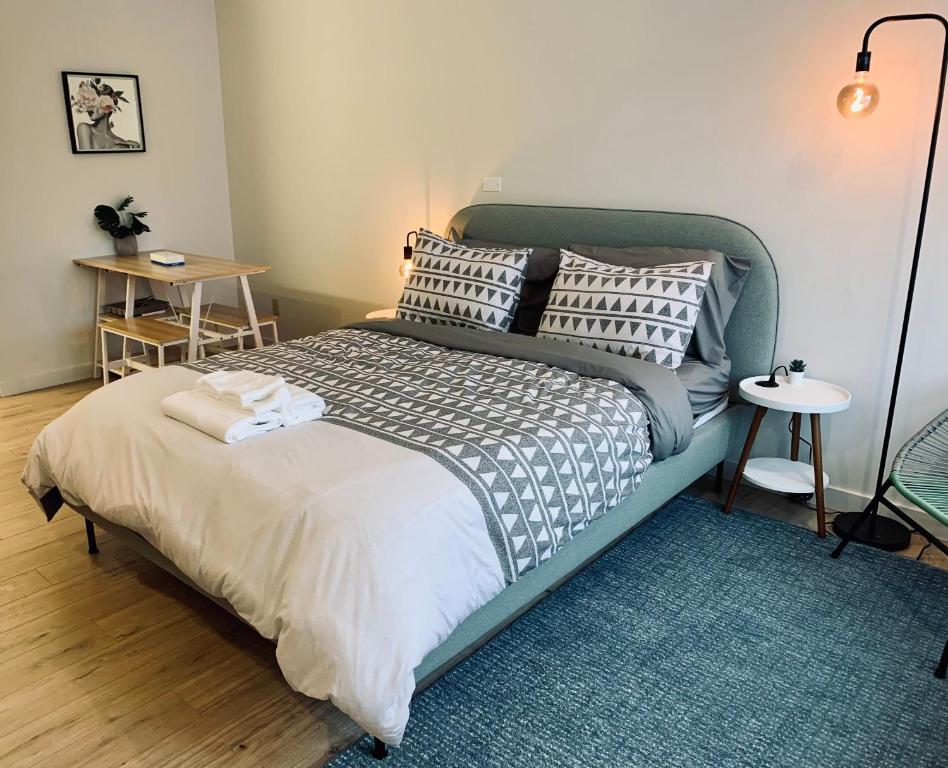 a bedroom with a bed with a green headboard at Urban Nest, Studio, Ground Floor in Halifax