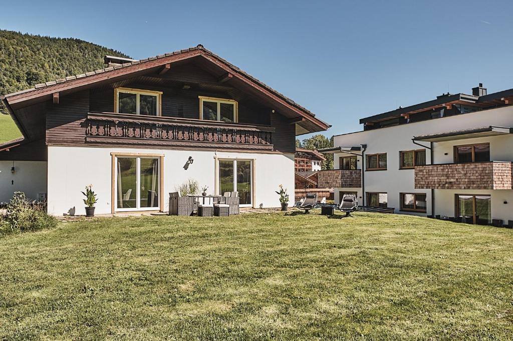 a house with a large yard in front of it at Ferienhaus Streif LXL in Kirchdorf in Tirol