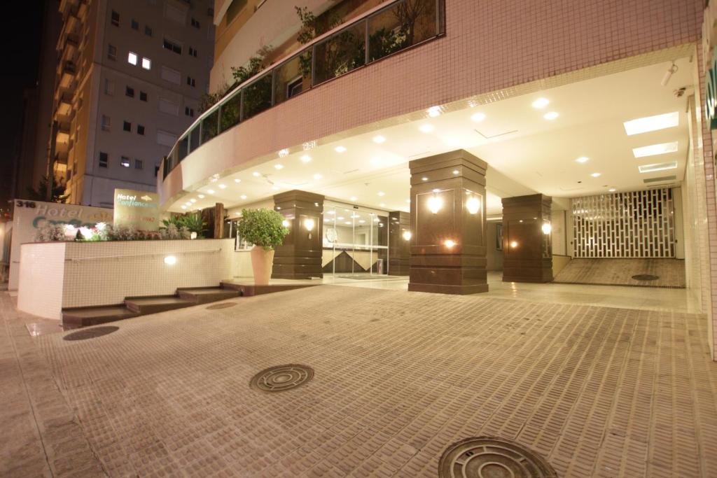 an empty lobby of a building at night at Hotel Confiance Batel in Curitiba