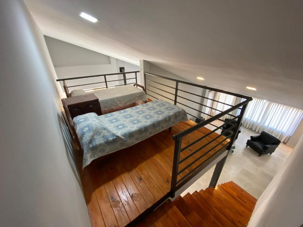 a bedroom with a bed in a loft at Casa del lago in Termas de Río Hondo