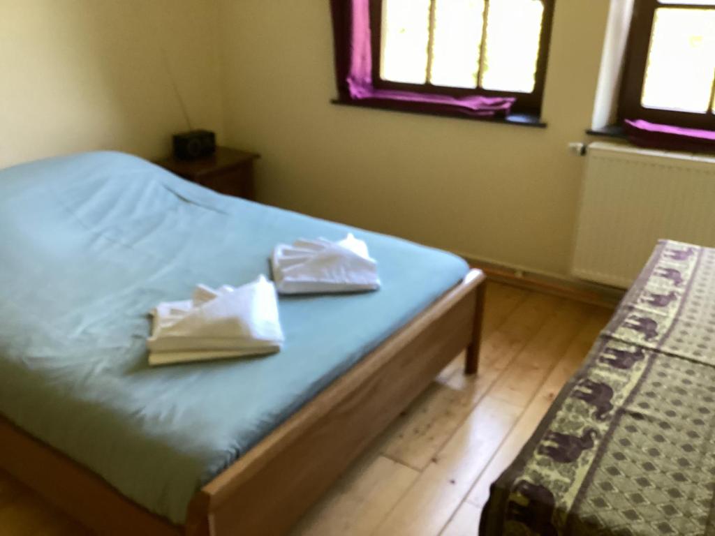 a bedroom with a bed with two towels on it at Auberge au pont de Villettes in Lierneux