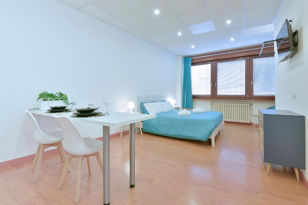 a room with a bed and a table and chairs at LHE Les Trois Merveilles in Cesena