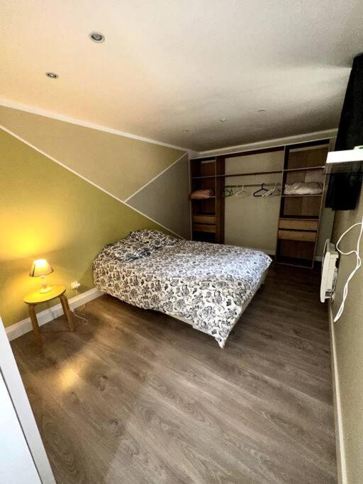 Dormitorio pequeño con cama y mesa en logement pour séjourner, en Aix-en-Provence