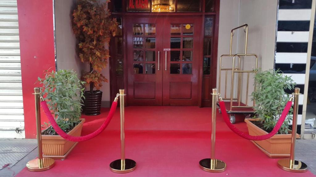 a red carpet leading to a red door with red ropes at Holiday homes in Dubai