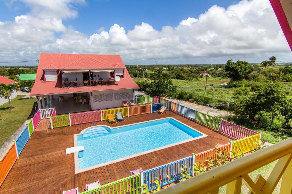 a house with a swimming pool on a deck at Chambres d'hôte Beauséjour in Beauséjour