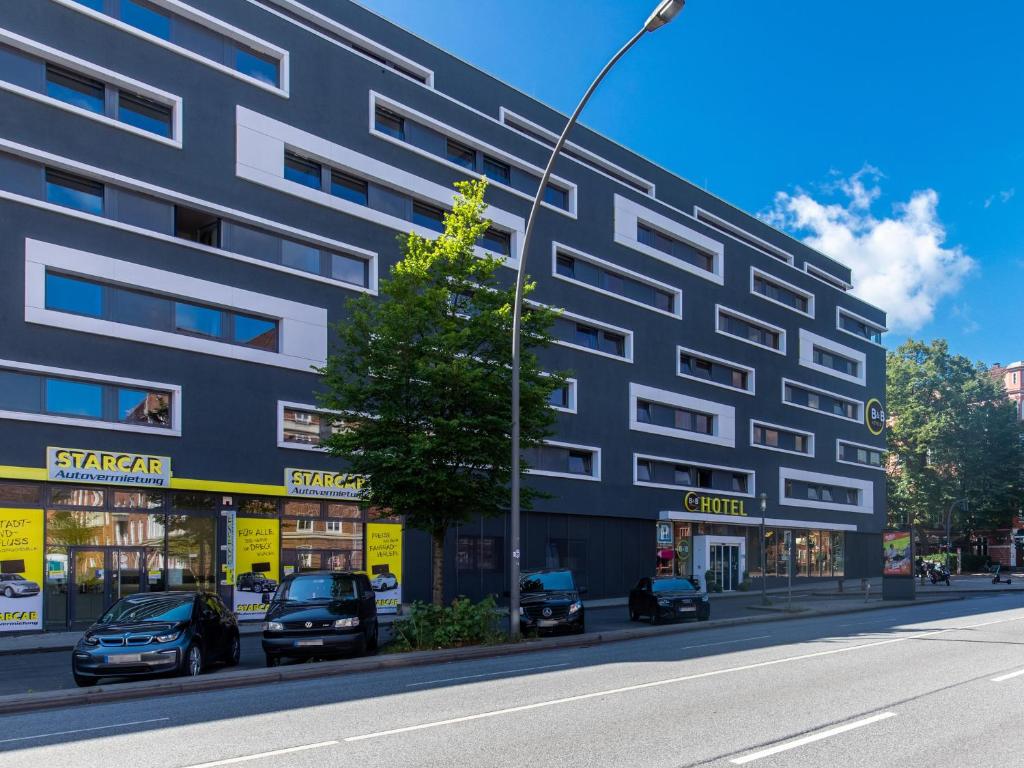 budynek na ulicy z samochodami zaparkowanymi przed budynkiem w obiekcie B&B Hotel Hamburg-Altona w mieście Hamburg