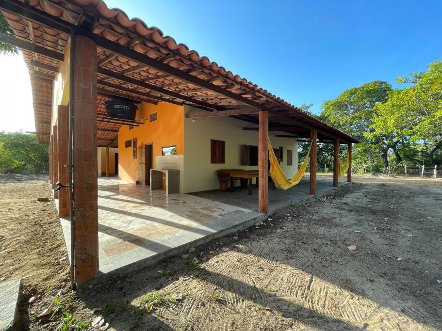a house with a patio with a slide at Casa na lagoa azul in Cruz