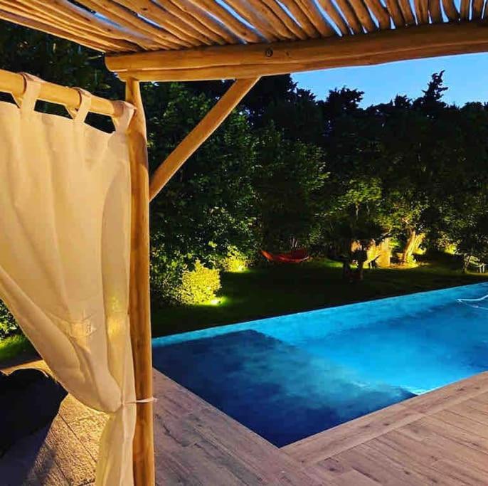 a porch with a pergola and a swimming pool at Un paradis avec piscine au cœur du village in Cassis