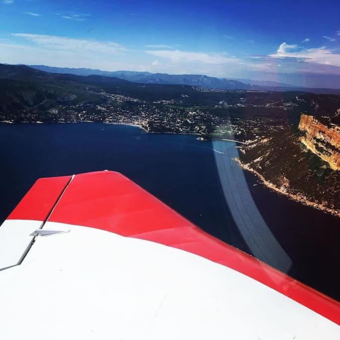 a view from the wing of an airplane flying over a body of water at Un paradis avec piscine au cœur du village in Cassis
