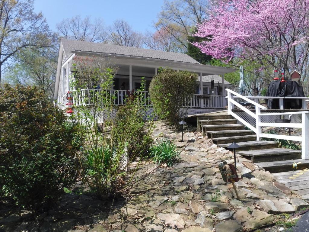 a house with a white fence and stairs in front of it at Serenity Hill Bed and Breakfast in Sloans Crossing