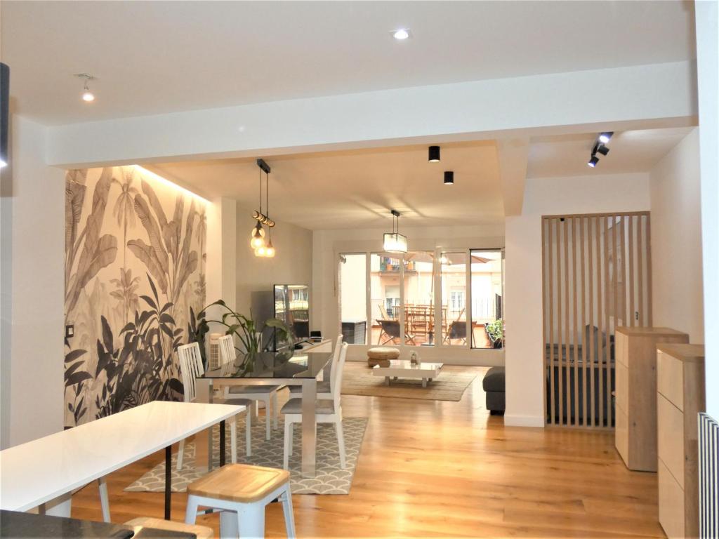 a dining room and living room with a table and chairs at GRAN BILBAO I in Barakaldo