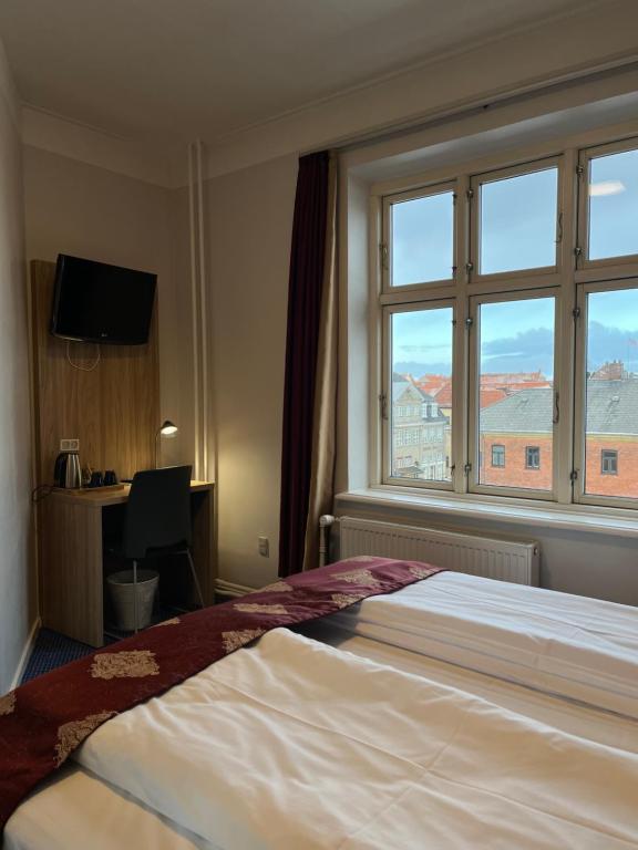 Postel nebo postele na pokoji v ubytování Hotel Skandia