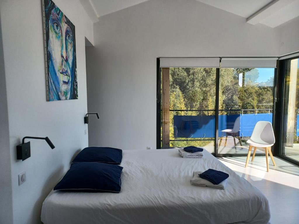 sypialnia z łóżkiem i dużym oknem w obiekcie Magnifique villa avec piscine, vue mer w mieście La Croix-Valmer