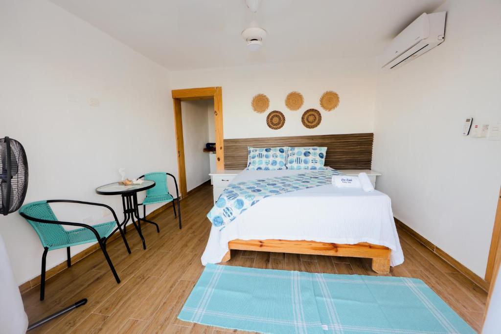Postel nebo postele na pokoji v ubytování Hotel Don Bululo Camping Lodge