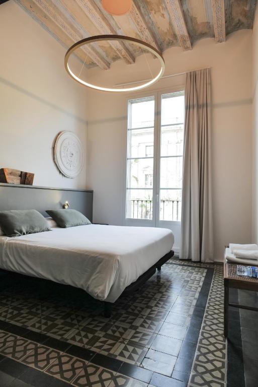 Postel nebo postele na pokoji v ubytování Hostal Porxos Garden