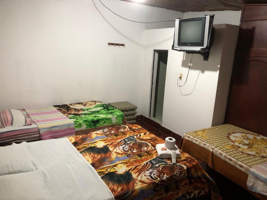 Postel nebo postele na pokoji v ubytování Hotel El Triangulo