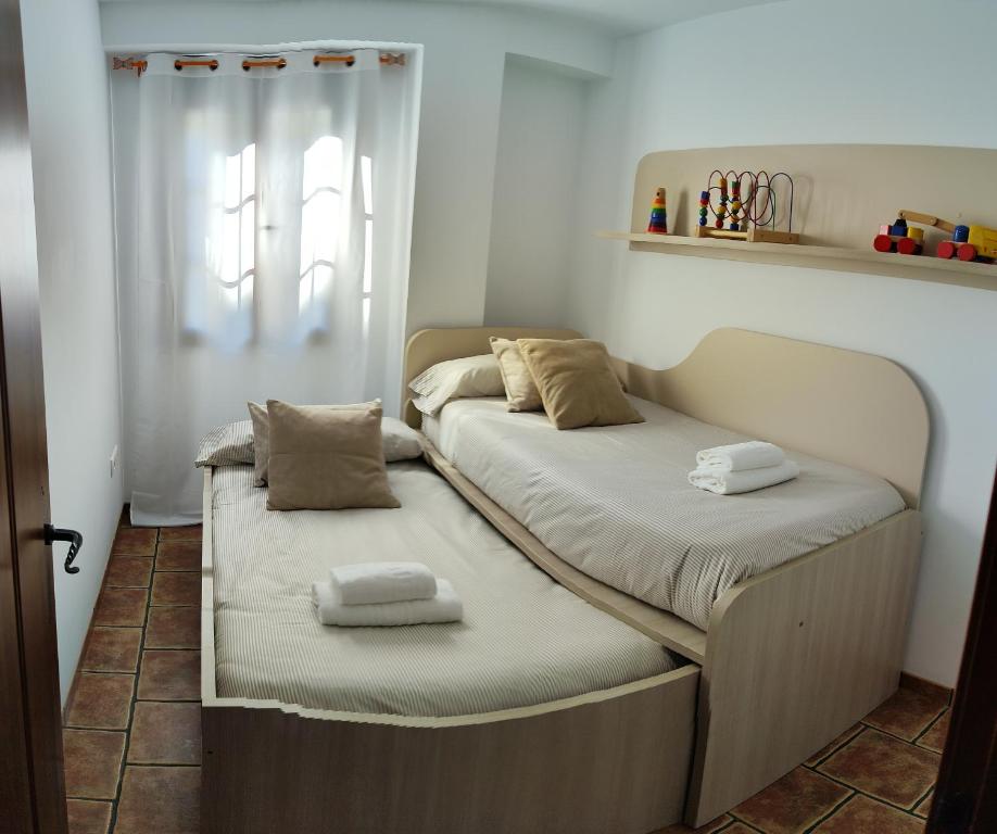 Postel nebo postele na pokoji v ubytování CASA LAURA