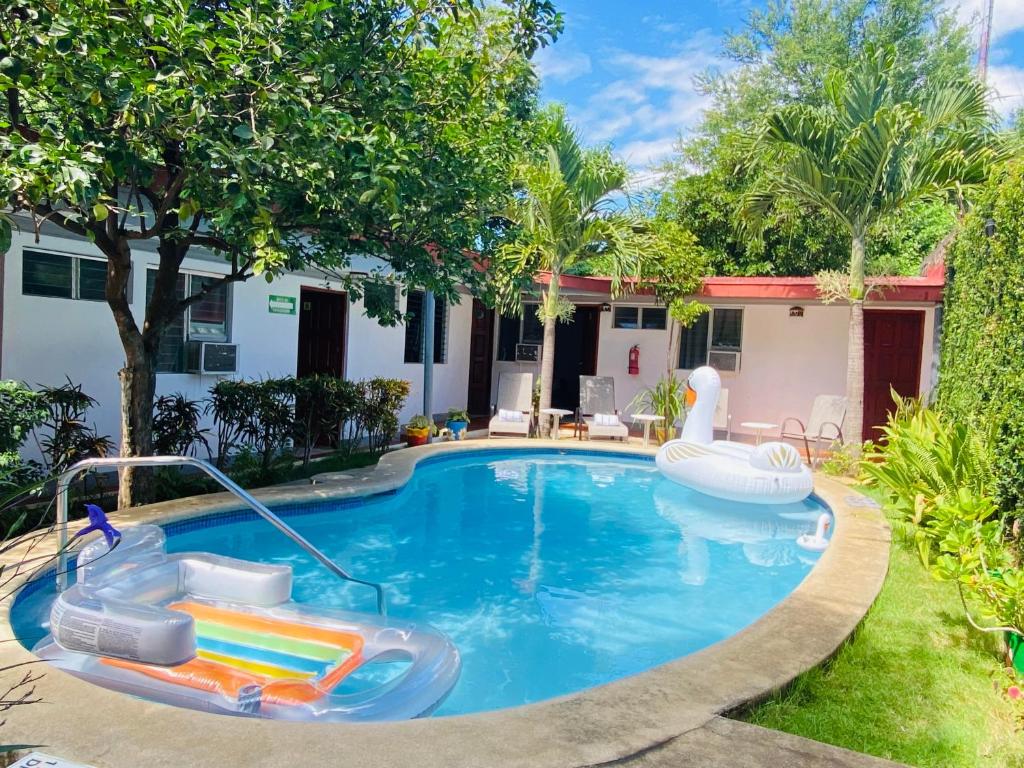 a swimming pool with a slide and an inflatable raft at Hostal Clary in León